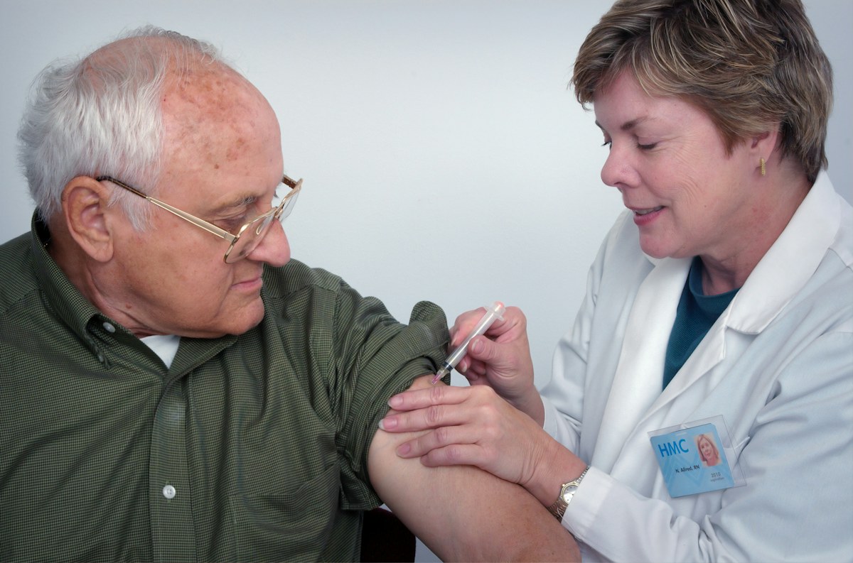 An older adult receiving care from a healthcare professional